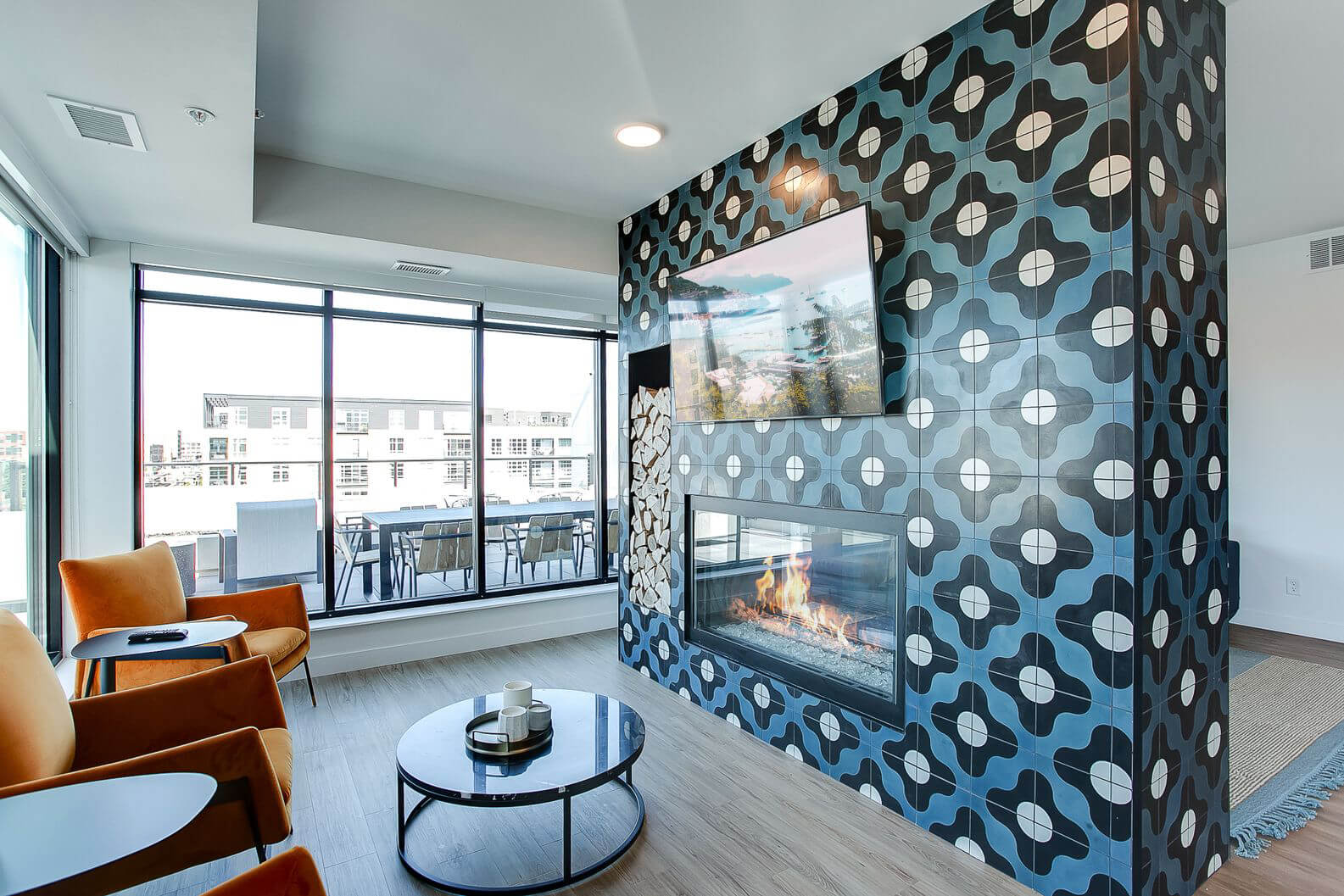 the midline apartments community fireplace and tv